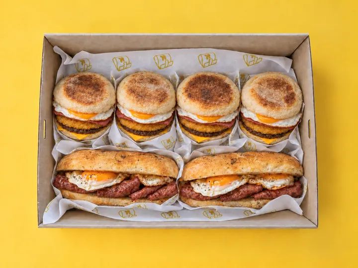 The Breakfast Box from above: four sausage and egg muffins and two beef rasher and egg rolls in a Kanteen catering box