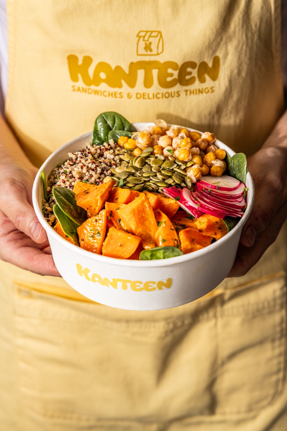 A fresh bowl held in front of a Kanteen apron