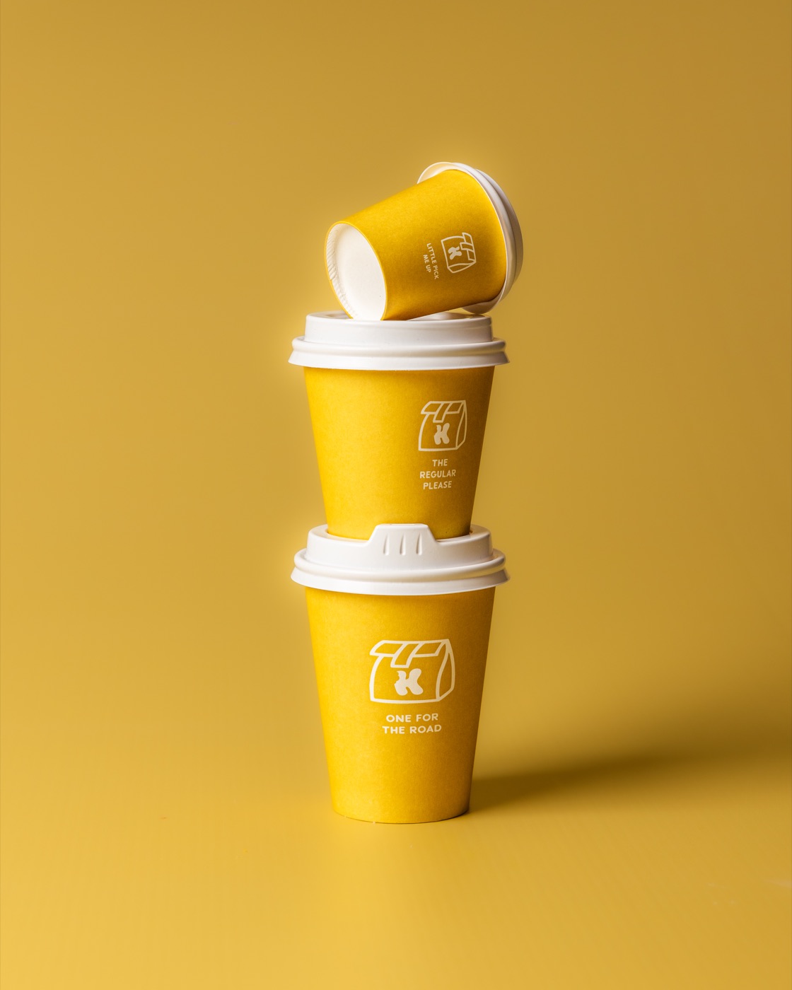 A stack of yellow Kanteen coffee cups